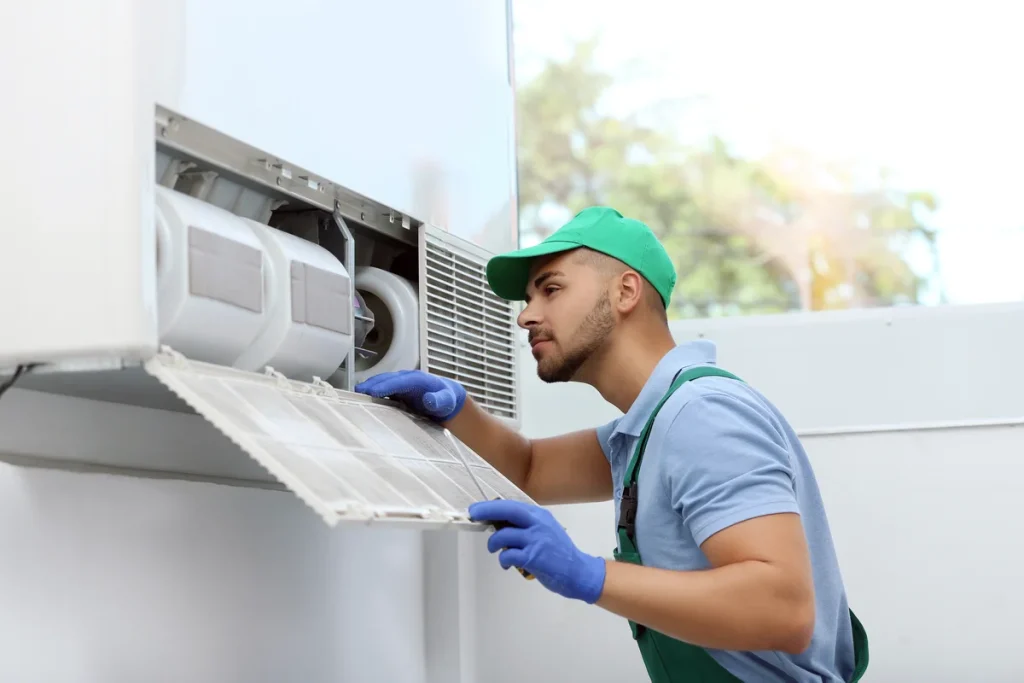 technician servicing a commercial air conditioning unit